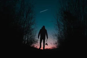 man looking at shooting star
